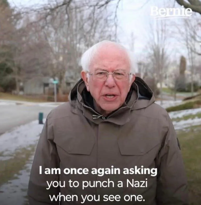 An older white man with glasses and white hair, wearing a brown hooded jacket, stands outdoors in a snowy residential area…