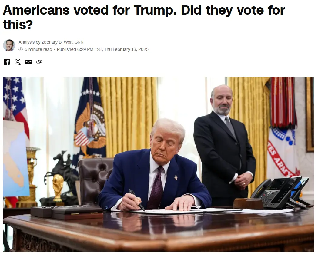 A photo shows Donald Trump seated at a large wooden desk in an office with American flags and golden drapes, appearing to…