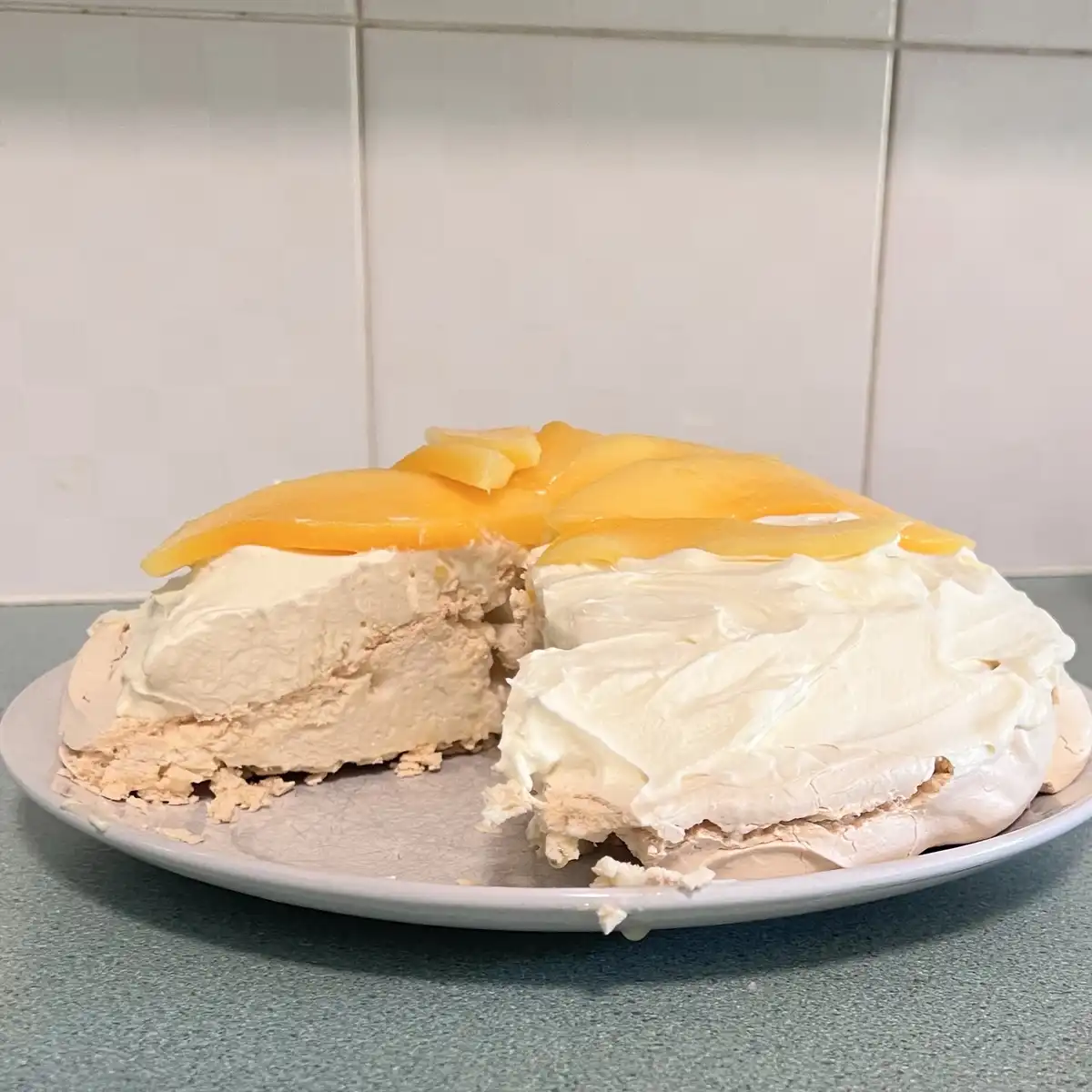 Delicious pavlova adorned with fresh mango slices