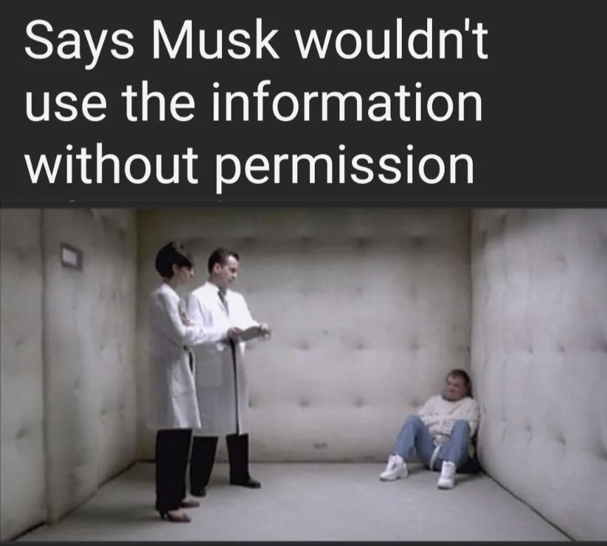 Two people in white lab coats stand in a padded room, looking down at a clipboard, while a third person sits slumped against…
