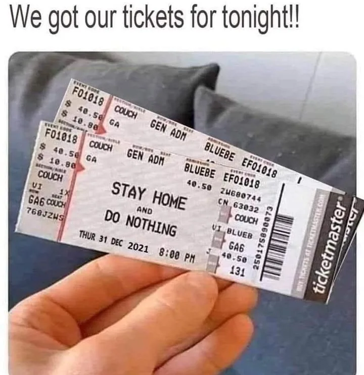 A hand holds up two mock concert tickets from Ticketmaster, printed with event code F01018 and venue BLUEBEE. The tickets…