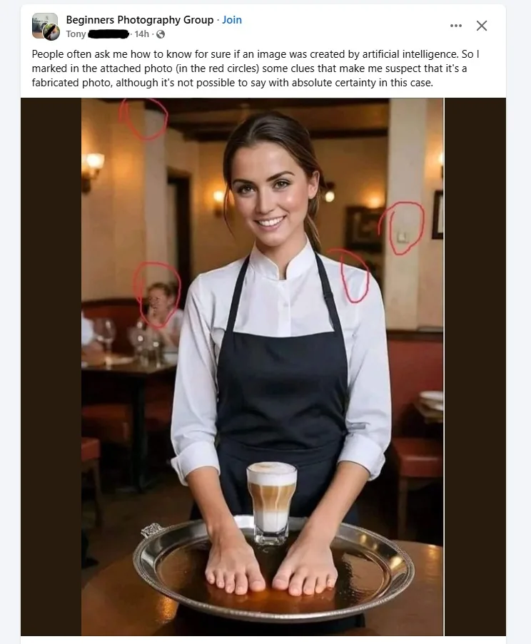 A woman in a black apron over a white shirt stands behind a table, holding a silver tray with a glass of layered coffee. Her…