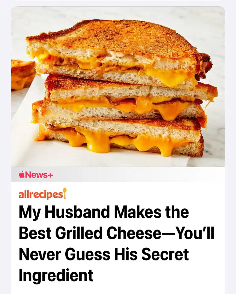 An image of a perfectly grilled cheese sandwich, cut in half and stacked, with melted cheese oozing out. The image is…