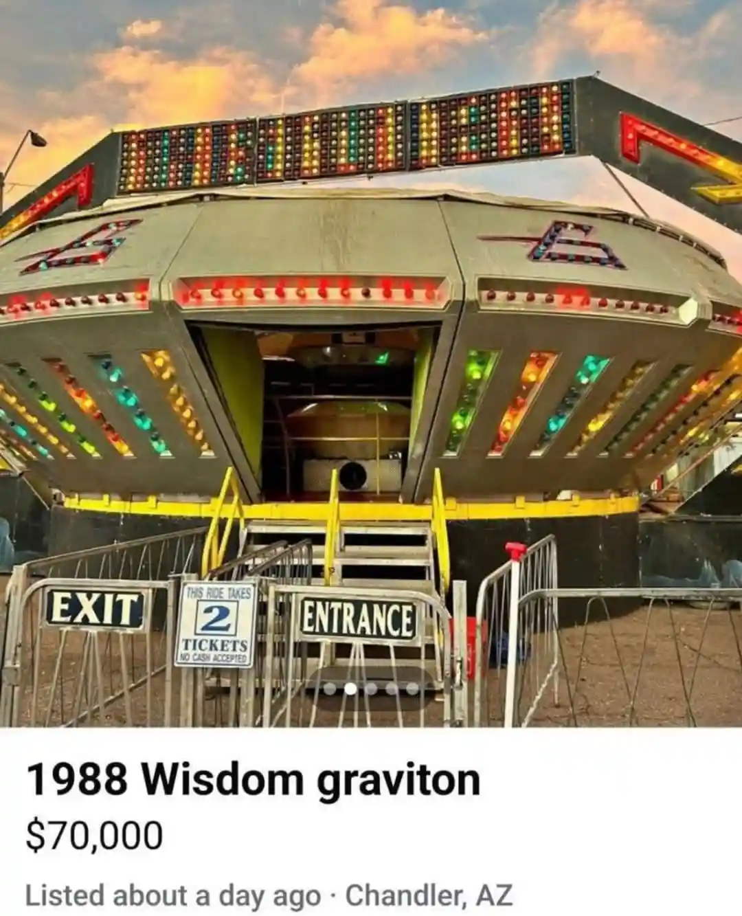 A photo of a large, retro-futuristic carnival ride with colorful lights and an open entrance/exit area, overlaid with text…