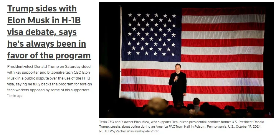 A man in a dark suit stands on a stage in front of a large American flag, holding a microphone. The image is overlaid with a…