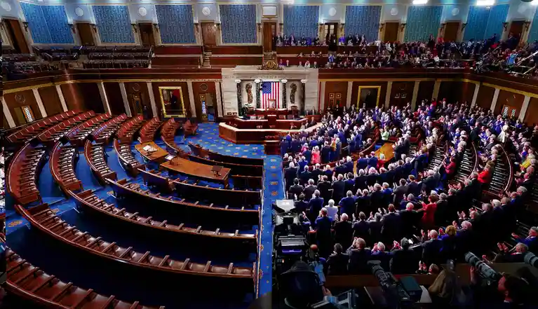 A split image shows the U.S. House of Representatives chamber: the left side is mostly empty with rows of vacant wooden…