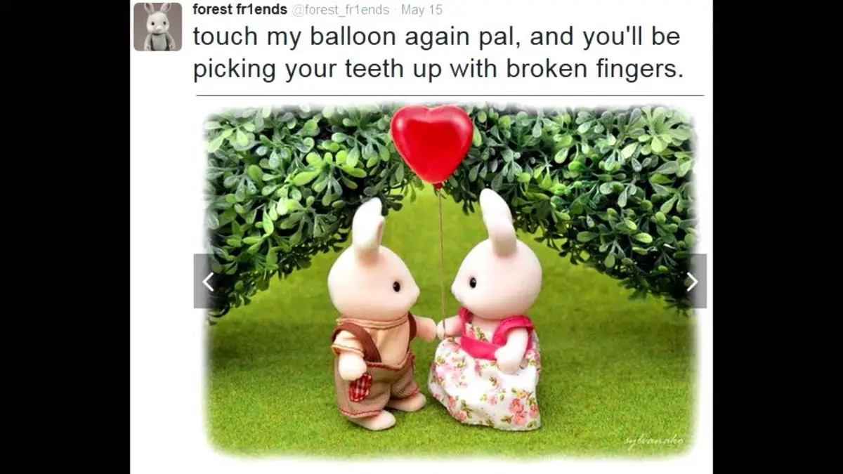 Two Sylvanian Families bunny figurines stand on green grass holding a red heart-shaped balloon between them, framed by green…