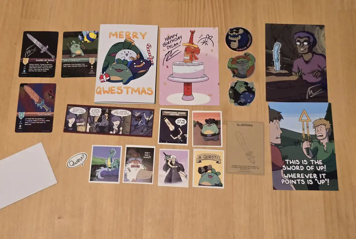A collection of fan art and cards from the game 'Quest' laid out on a wooden table, featuring characters like Quest Sprout…