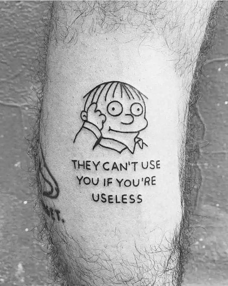 A black and white photo shows a tattoo on a hairy leg, depicting a cartoon character with large eyes and a collared shirt…