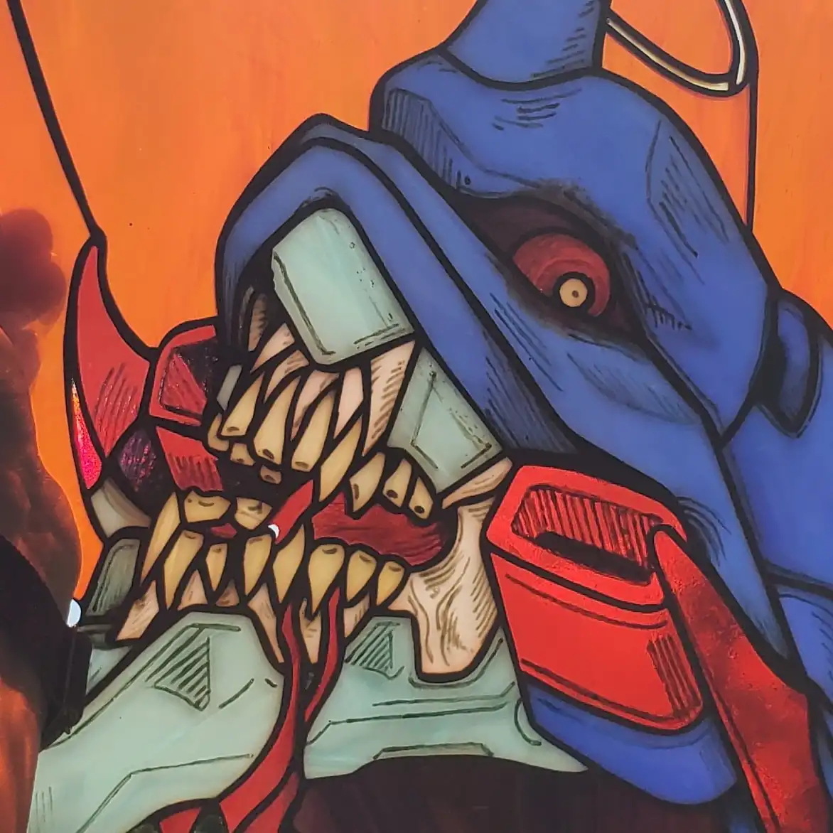 A stylized, cartoonish illustration of a blue, robotic-looking creature with a wide-open mouth showing sharp teeth and a red…
