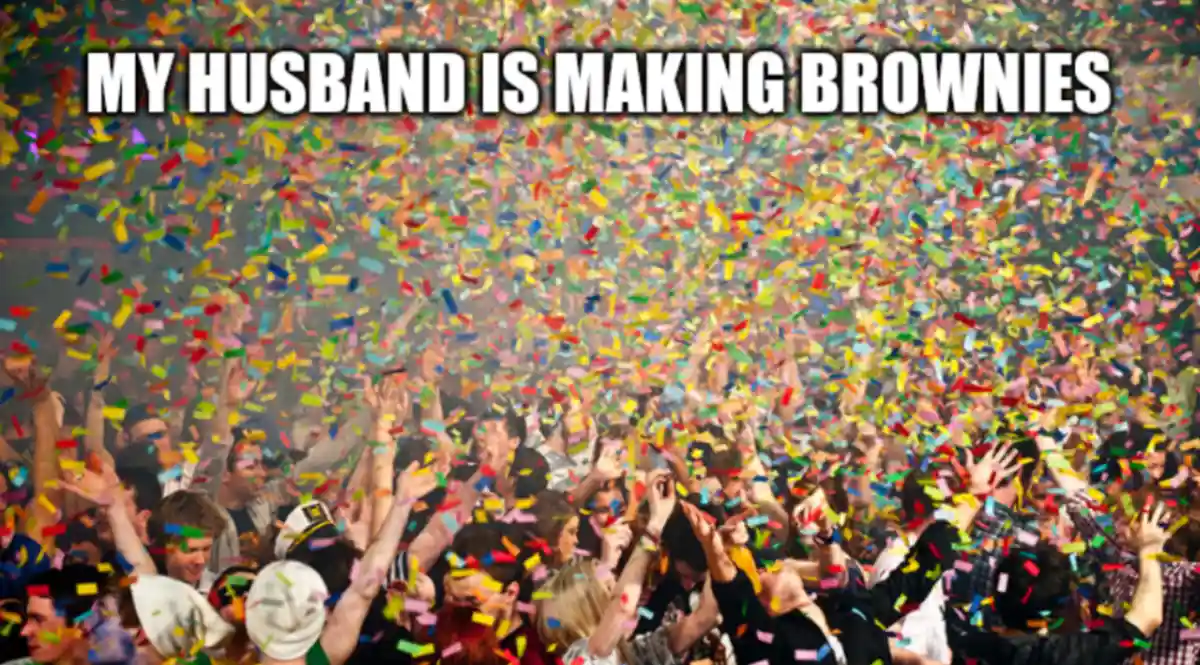 A crowd of people joyfully raising their hands under a shower of colorful confetti, with bold white text overlaid at the top…