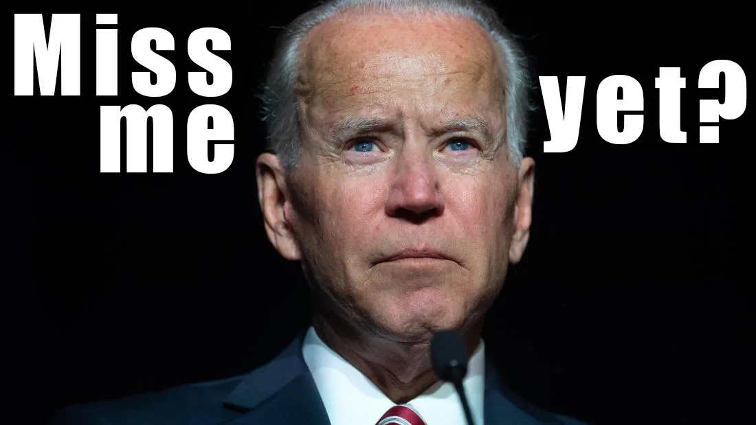 A close-up photo of Joe Biden looking serious and slightly downward, wearing a dark suit, white shirt, and red tie, with a…