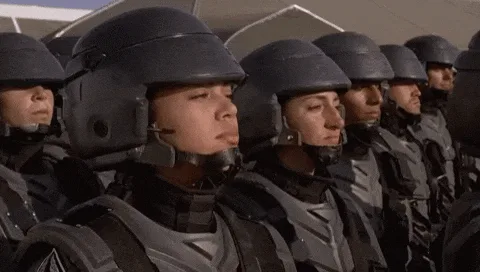 A composite image showing a sequence of frames from a movie where a young soldier in a helmet and uniform repeatedly says…