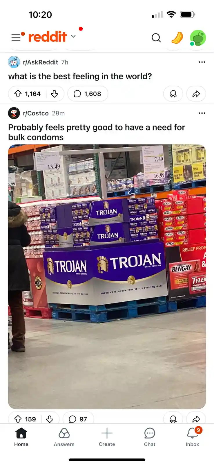 A screenshot of a Reddit post from r/Costco showing a large display of Trojan brand condoms stacked on a pallet in a…