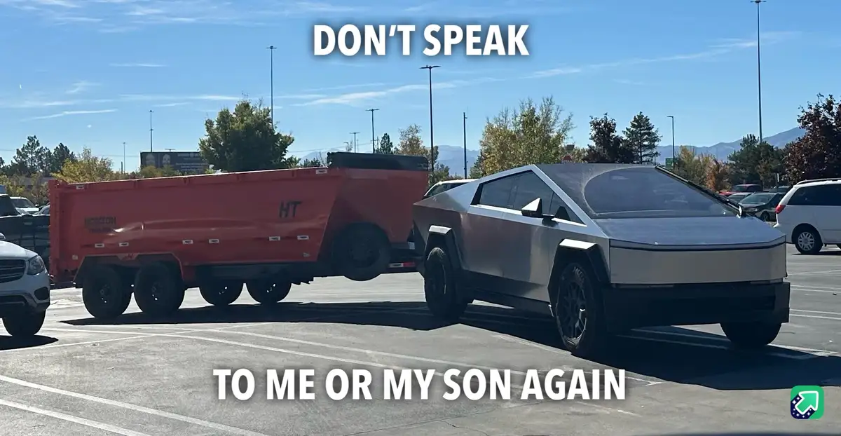 A silver Tesla Cybertruck is parked in a lot and is visibly towing a large red dump trailer. The trailer is tilted upward…