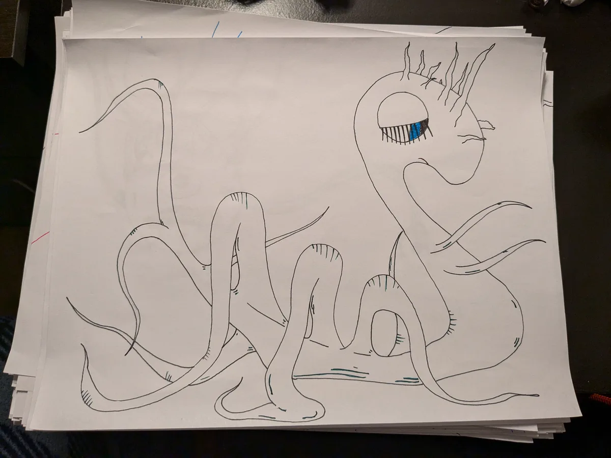 A hand-drawn sketch on white paper depicts a whimsical, multi-limbed creature with a large, expressive eye featuring blue…
