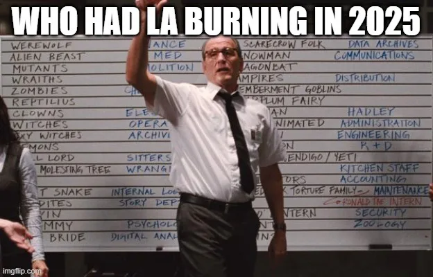 A man in a white shirt and tie stands in front of a whiteboard filled with handwritten monster and department names like…