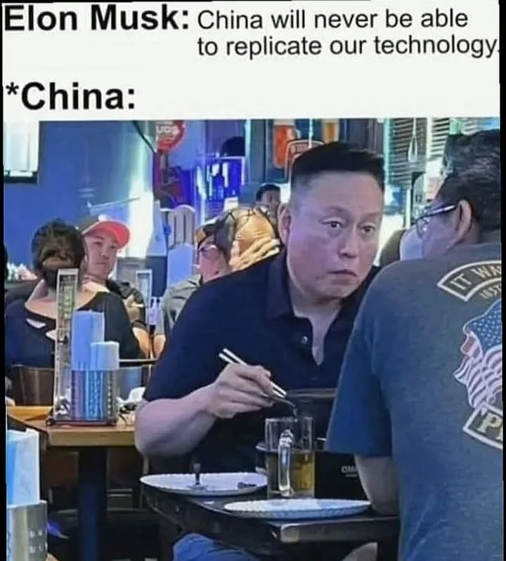 A man with a stern, unimpressed facial expression sits at a restaurant table, holding chopsticks over a bowl. The overlaid…