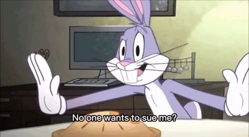 Bugs Bunny sits at a table with a pie in front of him, hands raised in a shrugging gesture, as if questioning why no one is…
