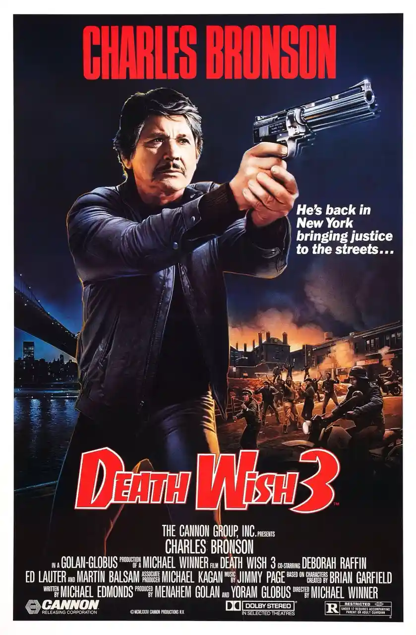 This is a movie poster for 'Death Wish 3' starring Charles Bronson, who is shown pointing a revolver forward with a serious…