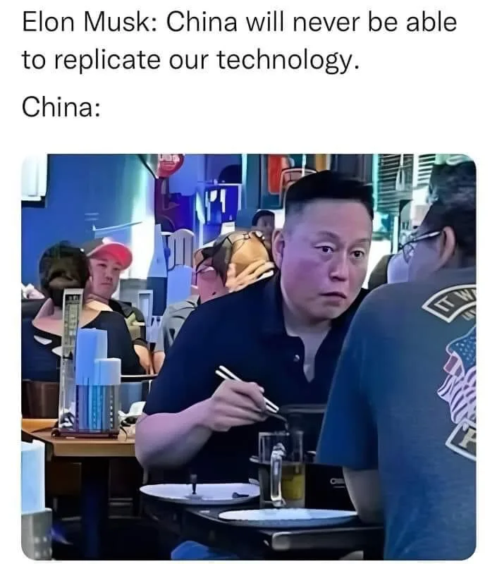 A man in a dark polo shirt sits at a restaurant table, holding chopsticks and looking intensely at someone across from him…