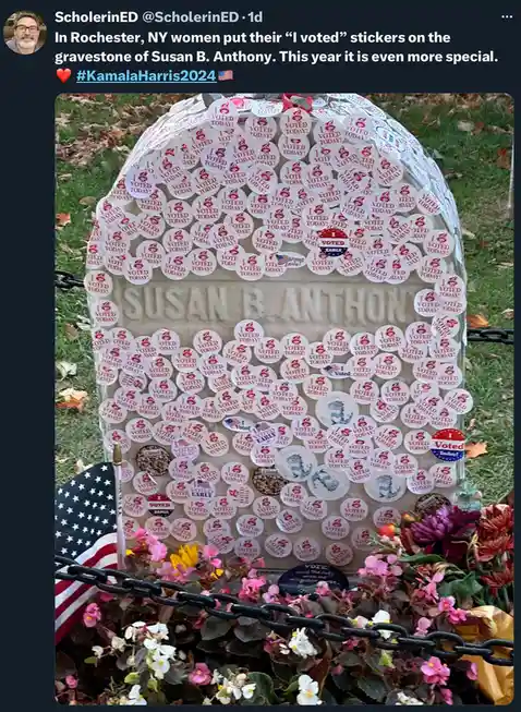 A gravestone for Susan B. Anthony is covered in hundreds of "I VOTED TODAY!" stickers, with an American flag and flowers at…