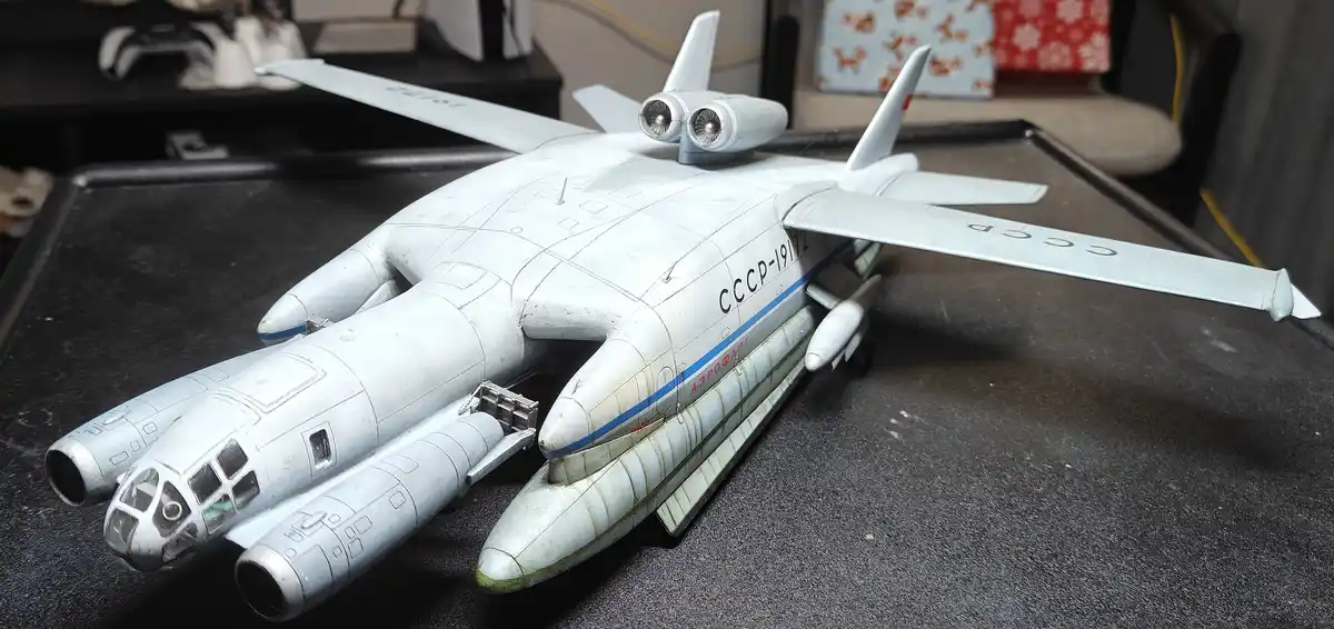 A detailed scale model of a Soviet-era aircraft, painted in light gray with 'СССР-19172' and 'АЭРОФЛОТ' markings, sits on a…