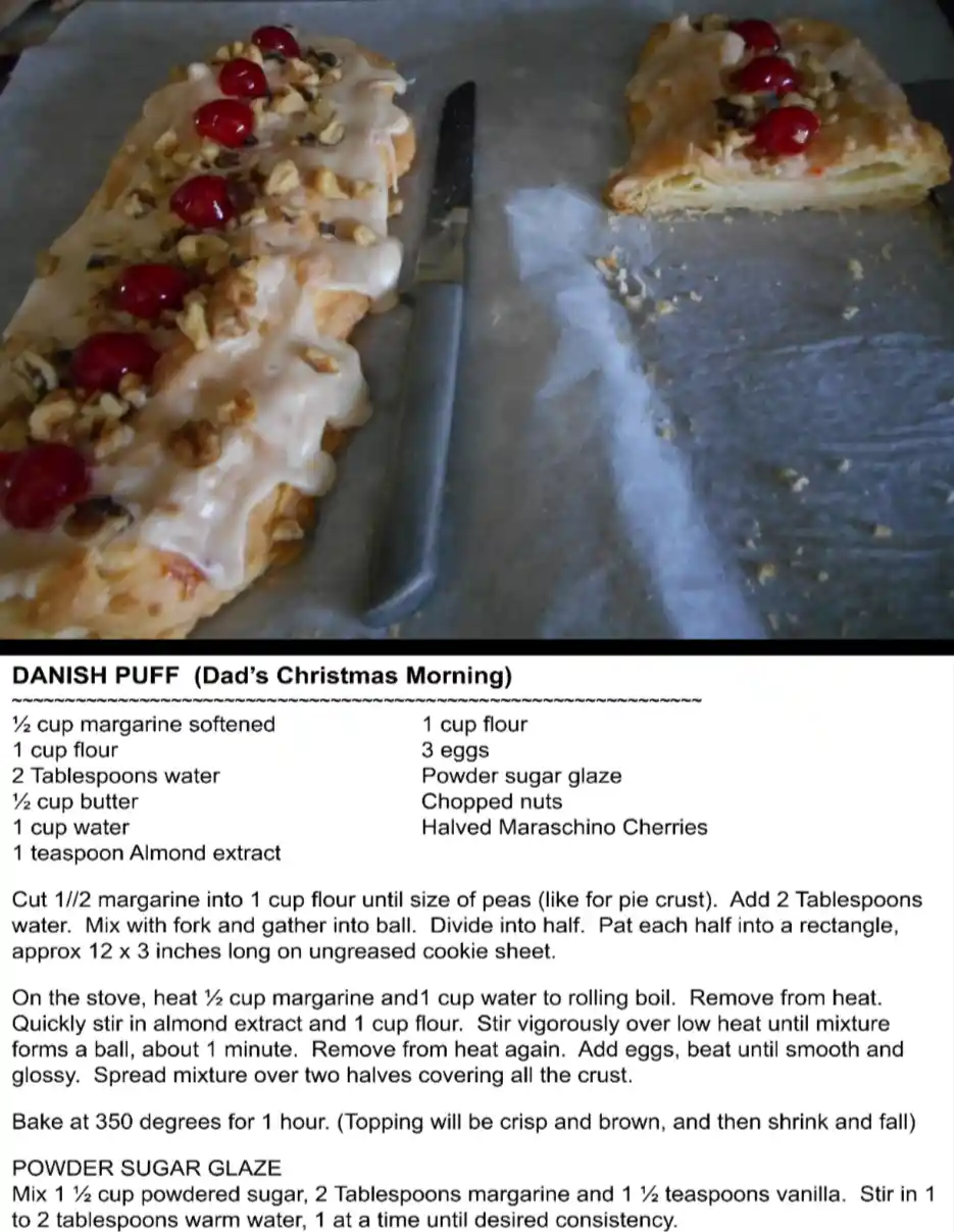 An image of a baked danish pastry with icing, nuts, and cherries, next to a knife on parchment paper, overlaid with a recipe…