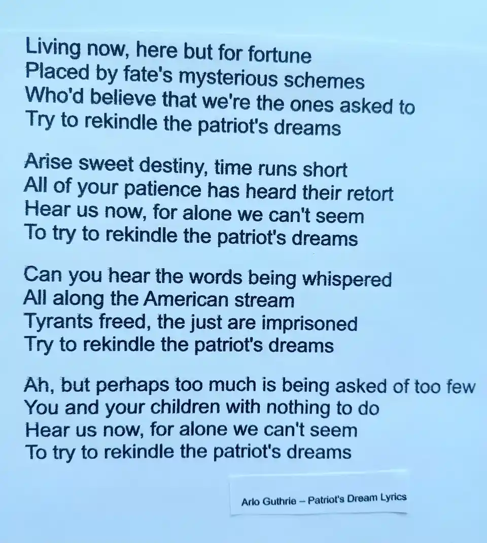The image displays a printed page of lyrics from Arlo Guthrie's song 'Patriot's Dream,' featuring stanzas that repeatedly…