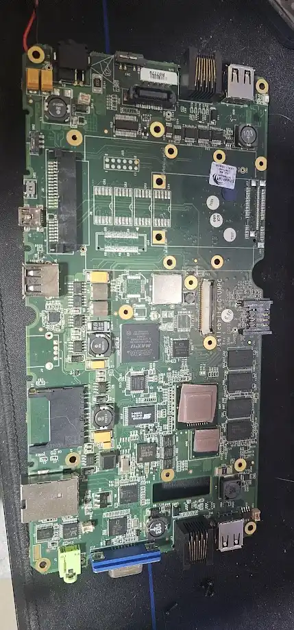 A close-up photo of a green computer motherboard with various chips, ports, and connectors visible, overlaid with the text…