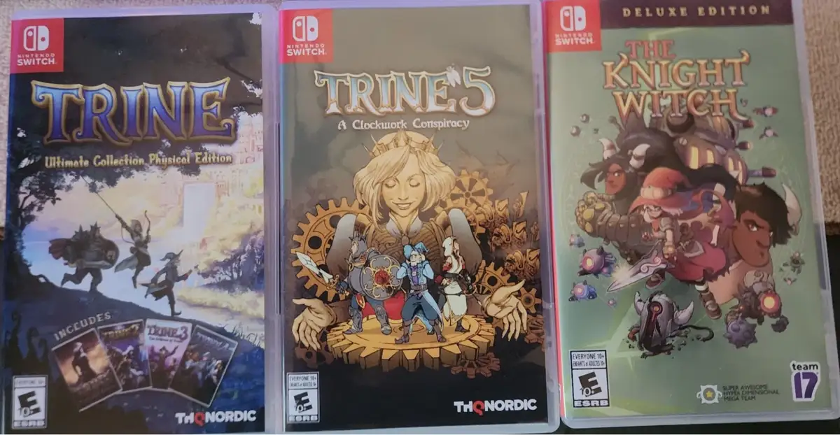 Three Nintendo Switch game cases are displayed side-by-side: 'Trine Ultimate Collection', 'Trine 5: A Clockwork Conspiracy'…
