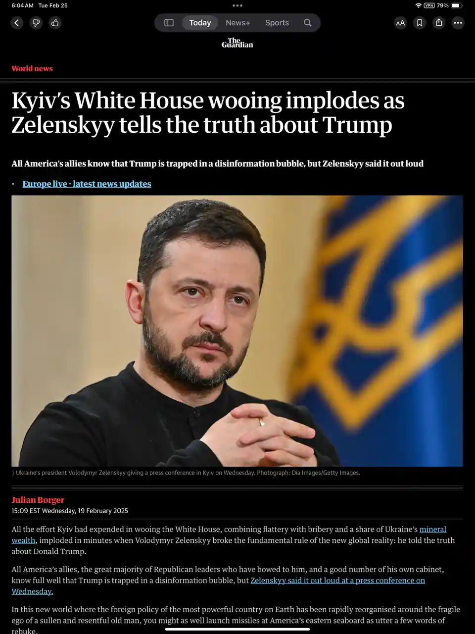 A screenshot of a The Guardian news article shows a photo of Ukrainian President Volodymyr Zelenskyy with a Ukrainian flag…