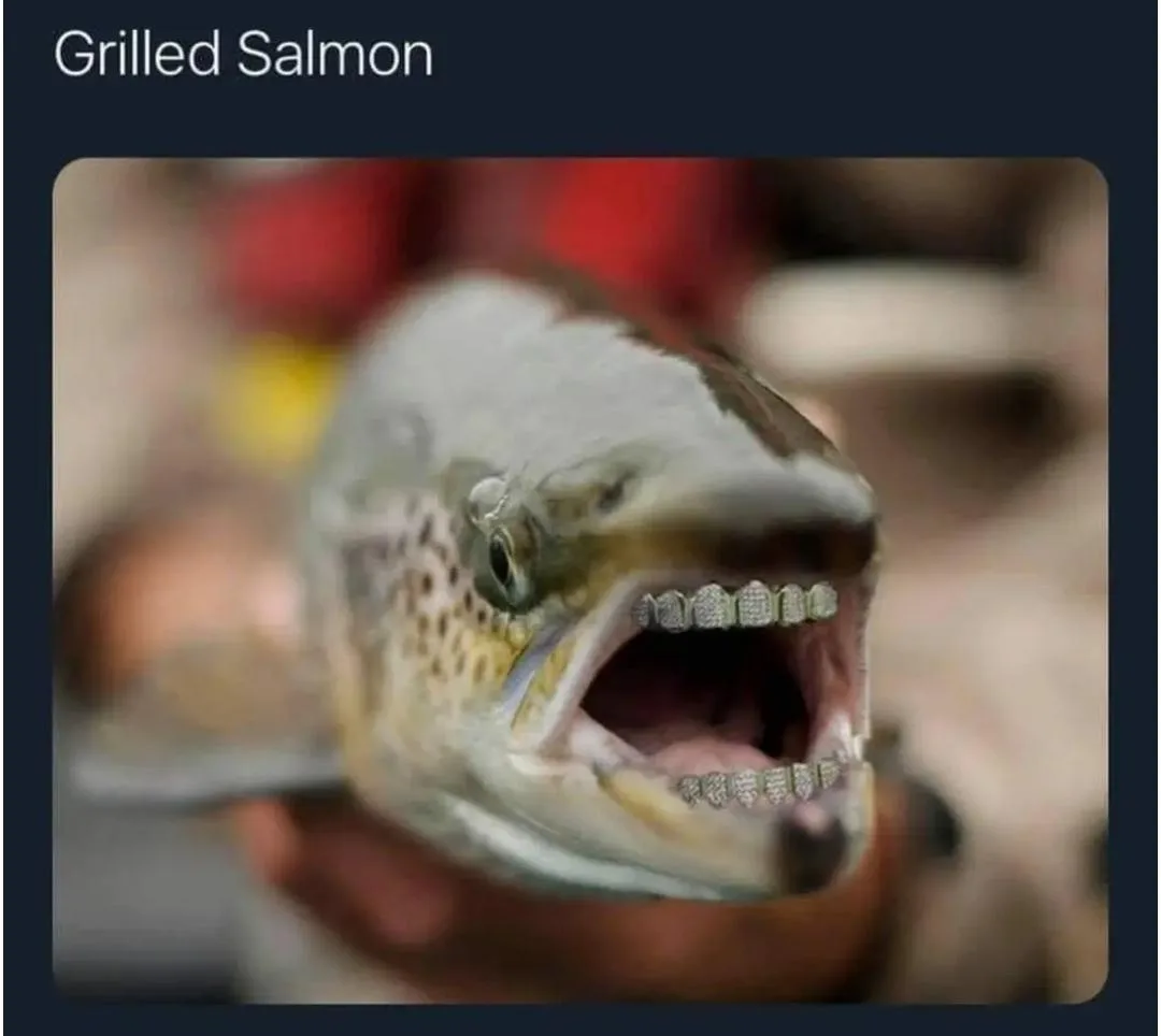 A close-up photo of a fish, likely a trout or salmon, with its mouth open to reveal teeth covered in diamond-encrusted…