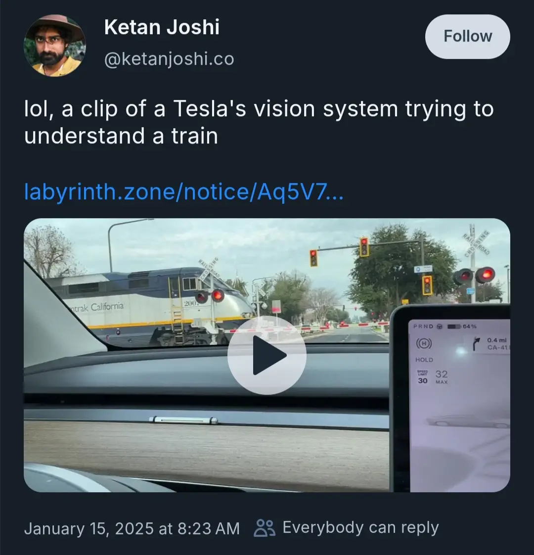 A screenshot of a tweet by Ketan Joshi showing a video from inside a Tesla. The video captures a train approaching a…