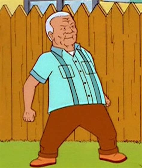 An elderly cartoon man with white hair, wearing a light blue shirt and brown pants, stands in front of a wooden fence with a…