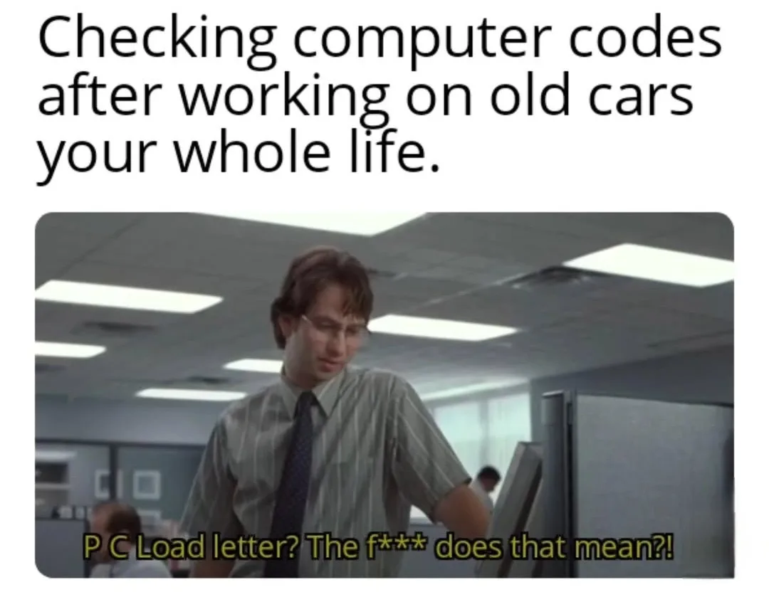 A man in a striped shirt and tie stands in an office, looking confused while staring at a computer monitor. The overlaid…