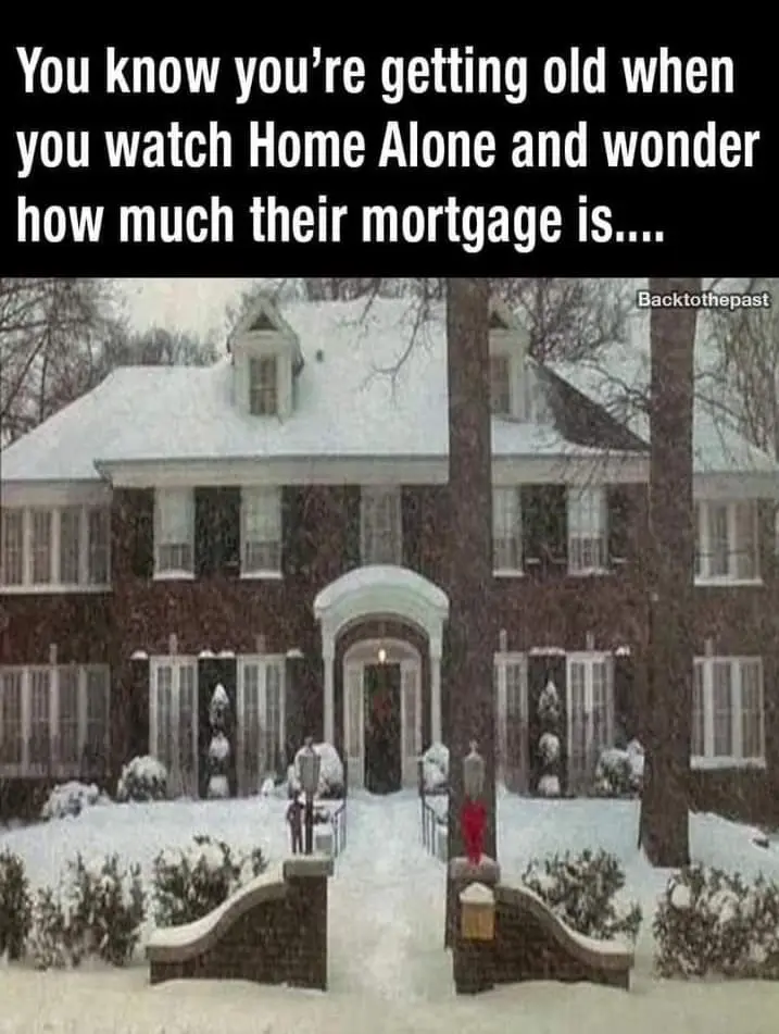 The image shows the large, snow-covered house from the movie 'Home Alone', with a snowy driveway and two small figures…