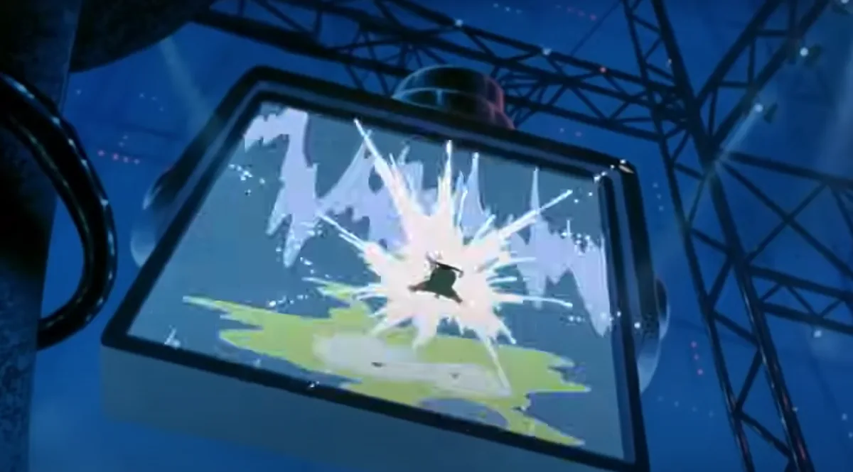 A close-up shot of a large, suspended screen displaying a bright, starburst-like explosion effect over a green and white…