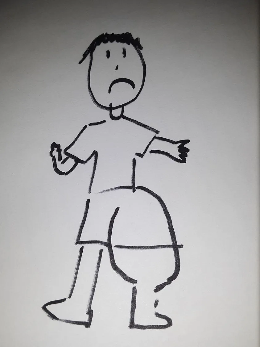A simple black-and-white stick figure drawing shows a person with a sad, downturned mouth and wide eyes, arms slightly…