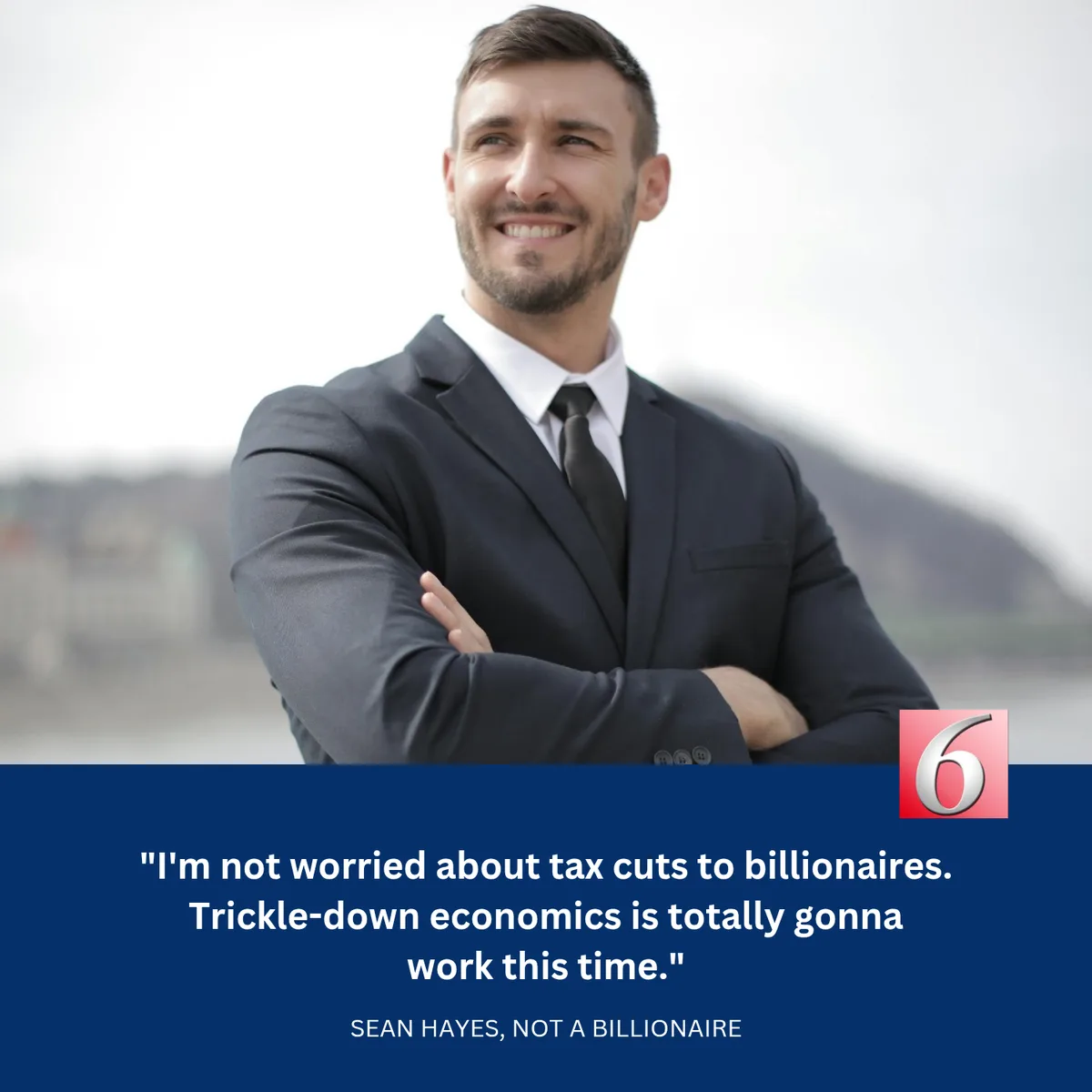A smiling man in a dark suit and tie stands with arms crossed against a blurred outdoor background. A blue banner at the…