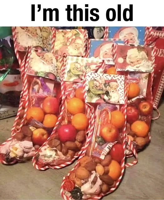 A photo shows multiple red-and-white striped Christmas stockings filled with fruit, nuts, and candy, with a Santa Claus…