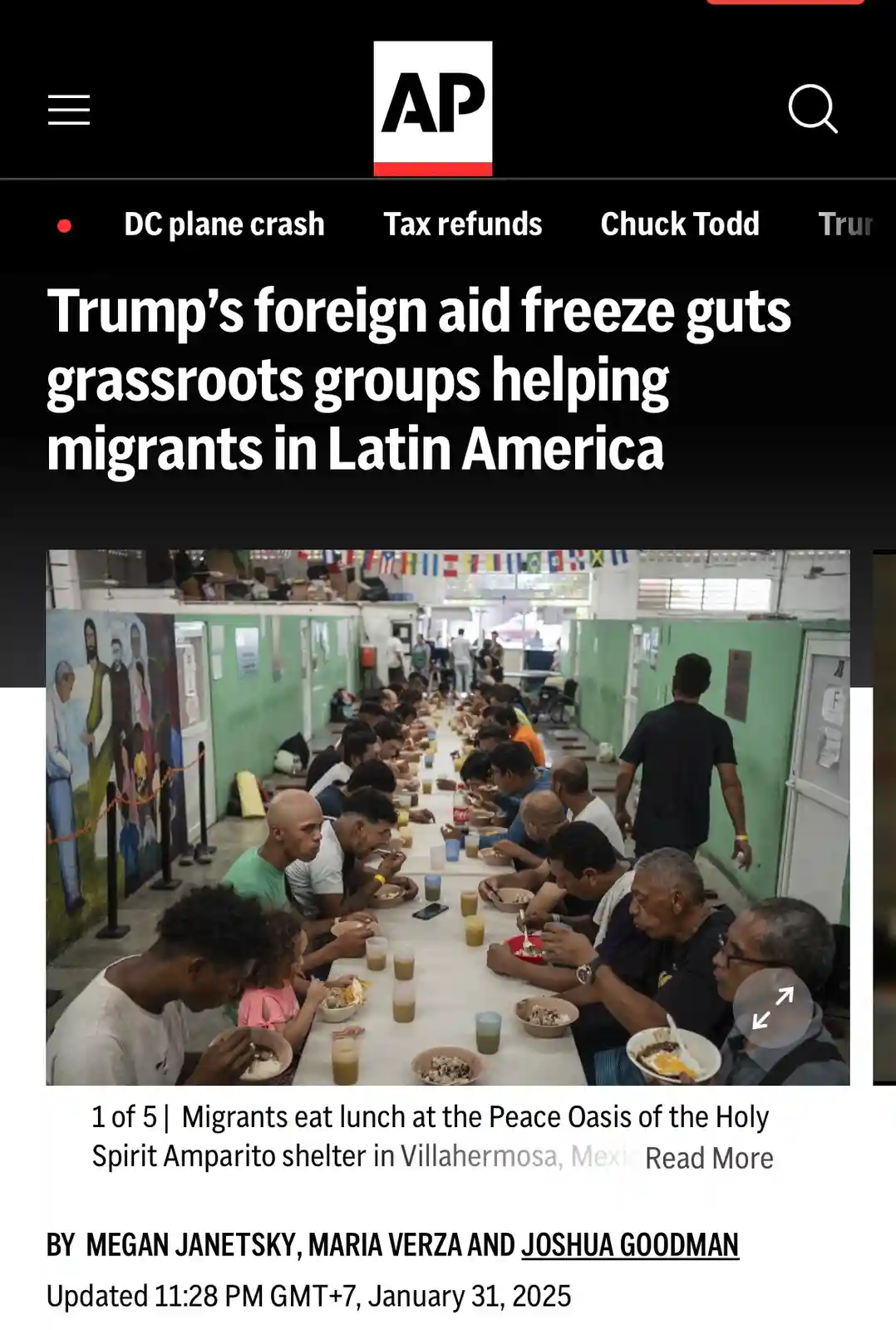 A screenshot of an Associated Press news article shows a photo of migrants eating lunch at a shelter. The headline reads…