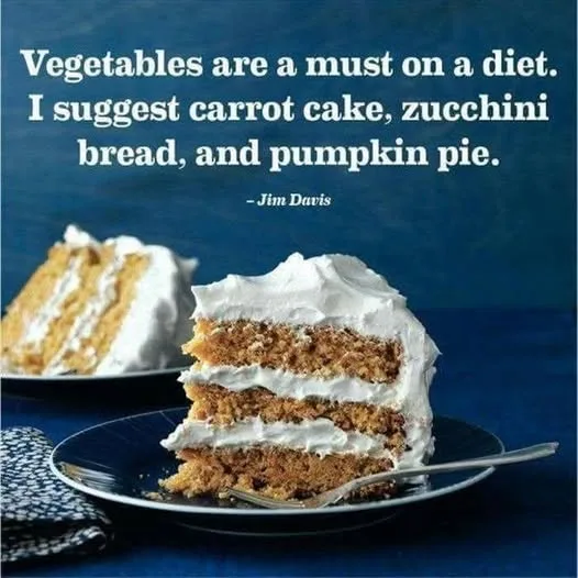 A close-up photograph shows two slices of layered carrot cake with white frosting on dark blue plates, set against a deep…