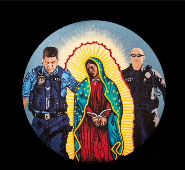 An image shows the Virgin of Guadalupe flanked by two ICE agents in uniform, one on each side. The Virgin is depicted with a…