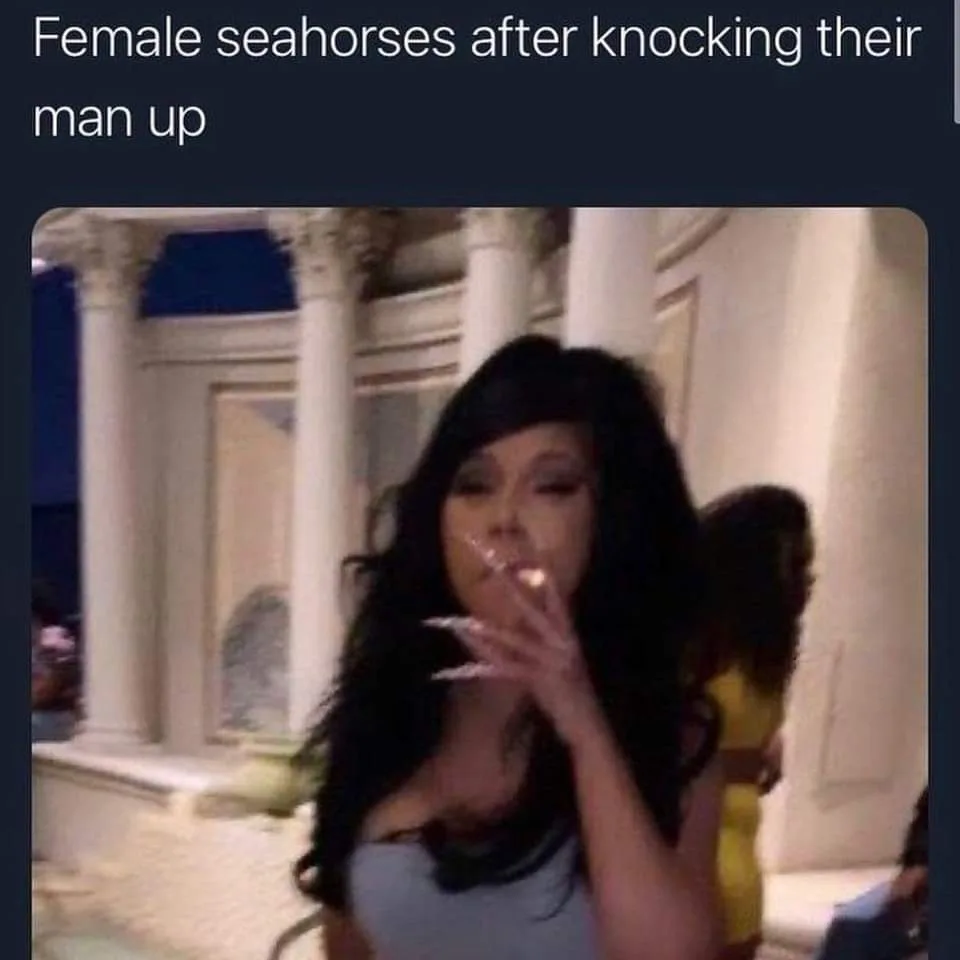 A woman with long dark hair and long, pointed fingernails is holding a lit cigarette to her lips, looking smugly at the…