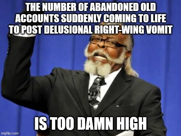 A man with a white beard and glasses, wearing a suit and tie, raises his right arm in a gesture of exasperation against a…