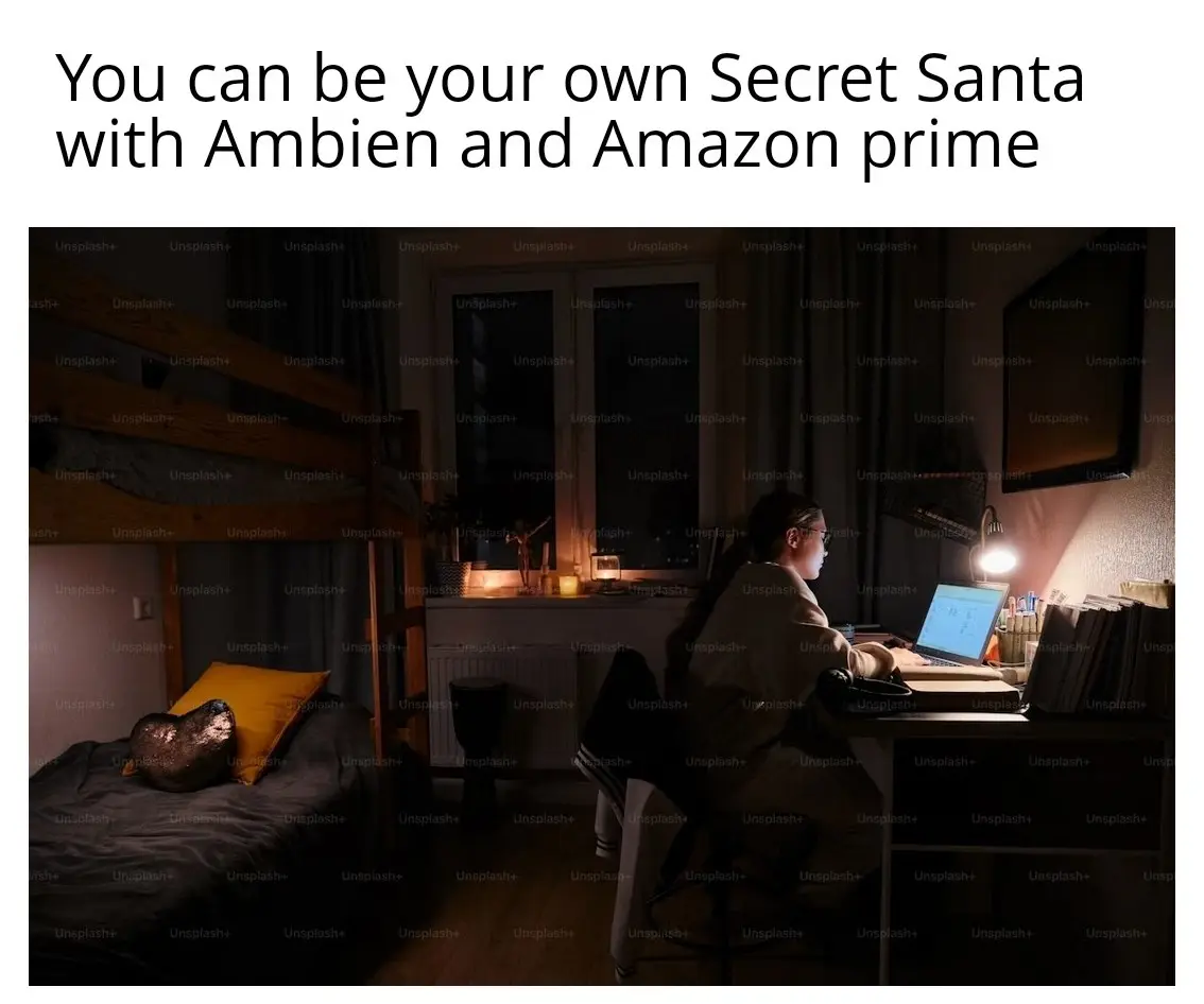 A person sits at a dimly lit desk in a bedroom at night, working on a laptop while wearing glasses and a robe. The room has…