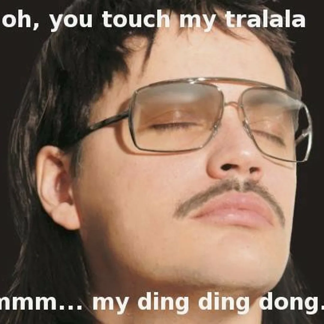 A close-up of a man with long dark hair, thick-rimmed sunglasses, and a mustache, eyes closed with a serene expression…