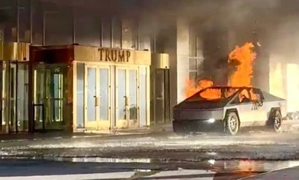A Tesla Cybertruck is on fire in front of a building with a golden 'TRUMP' sign above its entrance. The vehicle is engulfed…