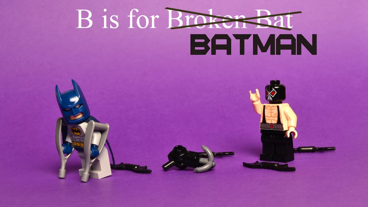 A purple background features a LEGO Batman figure using crutches, with his broken bat-like arms and legs scattered around…
